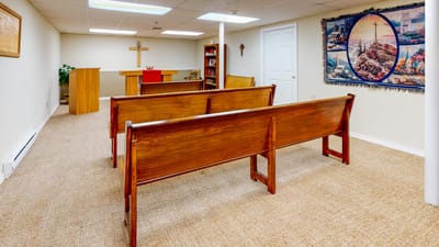 Interior view of a chapel with wooden benches
