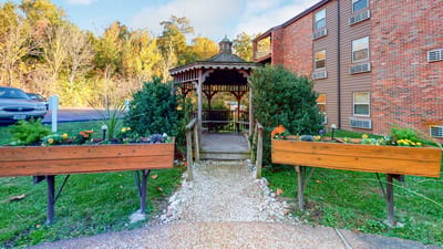 Beautiful garden gazebo surrounded by flowers
