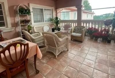 Outdoor seating area with plants and furniture