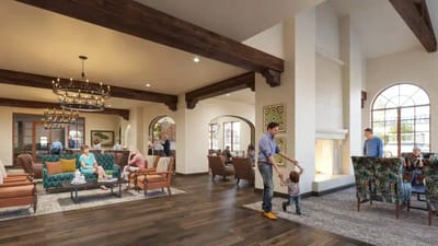 Bright common area with residents and staff interacting