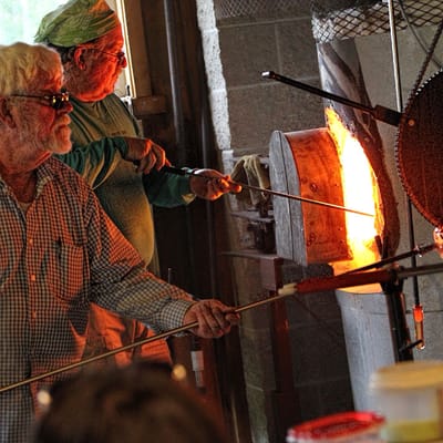 Residents participating in a glassblowing activity