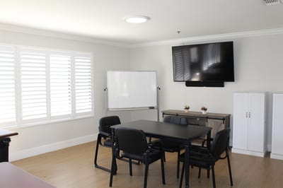 Bright activity room with a table and chairs