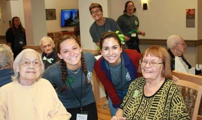 Residents and staff celebrating in a common area
