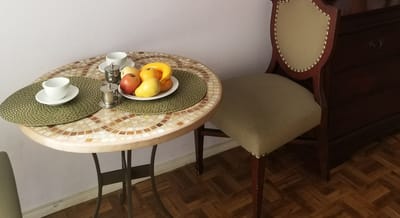 Table setting with fresh fruit and cups in a cozy dining area