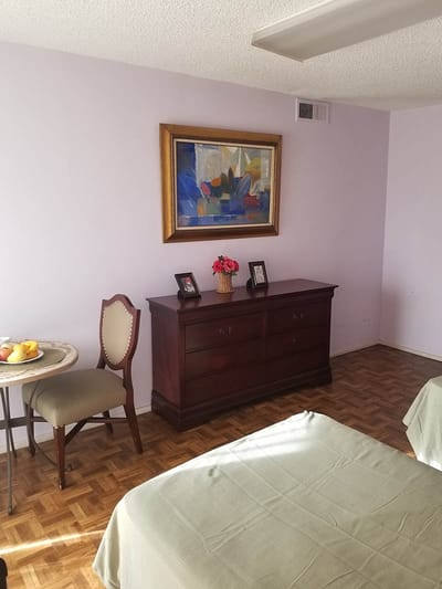 A cozy resident room with a bed and a view