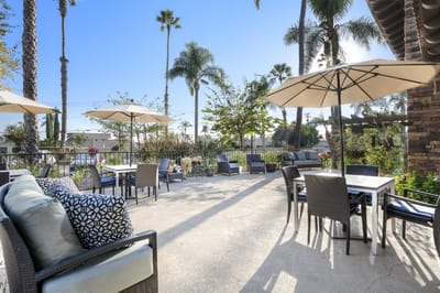 Outdoor patio area with seating and umbrellas