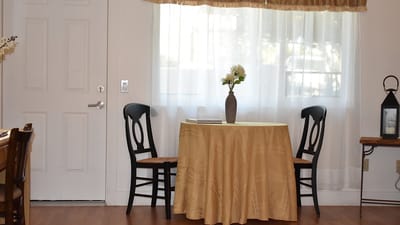 Cozy interior with a table and chairs by the window
