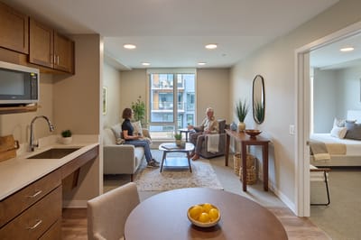 Residents chatting in a cozy living space