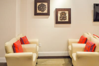 Fook Hong Sf Care Home, Inc., Nursing Home in San Francisco, CA — Lounge area with white chairs and decorative art