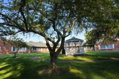 A gazebo surrounded by green spaces at the facility