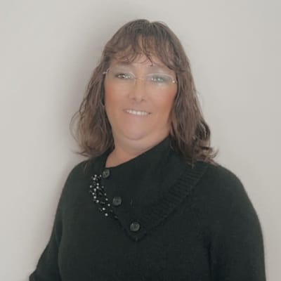 A woman smiling in a black sweater