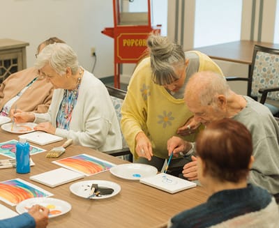 Residents participating in a painting activity