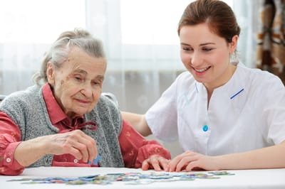 A caregiver and resident enjoying a puzzle activity