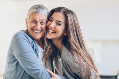 A resident and staff member sharing a joyful moment