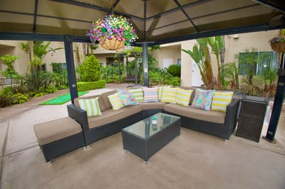 Outdoor seating area with comfortable couch and plants