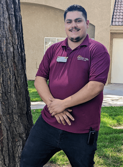 Staff member posing outdoors in front of a facility