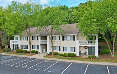 Exterior view of Crescent Oaks facility with green landscape