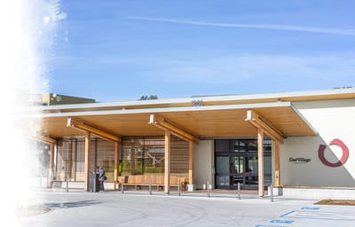 Building entrance of Enso Village with two people conversing