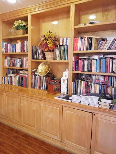 Bookshelves filled with various books and decor items