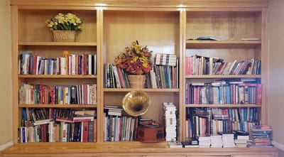 Bookshelves with various books and a vintage record player