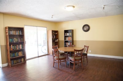 Bright common area with bookshelves and a table