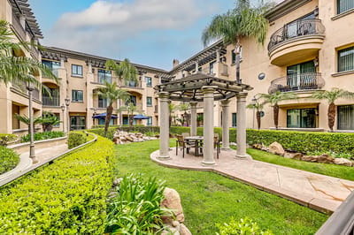 Outdoor seating area with greenery and architecture