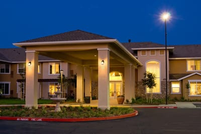 Exterior view of a senior living facility at night