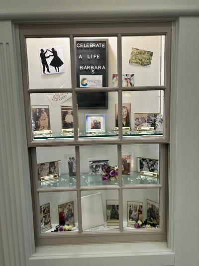 A display celebrating a resident's life with photos and decorations