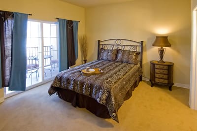 Cozy bedroom with a decorated bed and side table