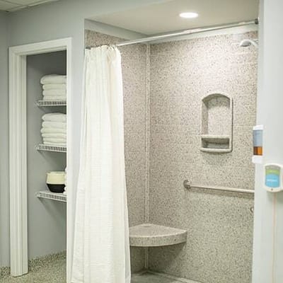 Accessible shower area with grab bars and towels
