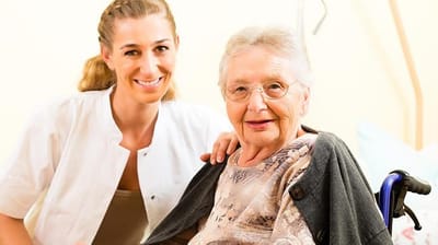 Orchards Assisted Living, assisted living in Medford, OR — Smiling caregiver and elderly resident in a nursing facility