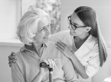 Orchards Assisted Living, assisted living in Medford, OR — Caregiver assisting elderly woman in a warm indoor setting