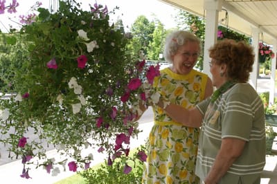 Orchards Assisted Living, assisted living in Medford, OR — Senior residents enjoying flowers and each other's company