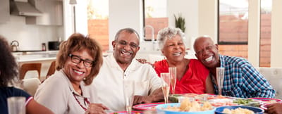 Happy seniors enjoying a meal together in a common area