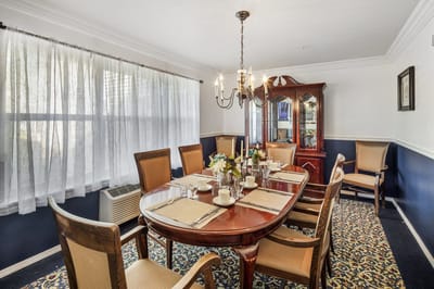 Dining room setup with a large wooden table and chairs