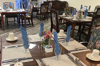Dining area set for a meal with blue napkins