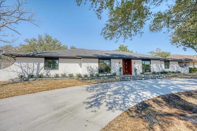 Exterior view of a senior living facility with landscaping