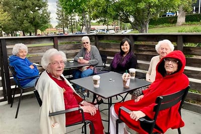 Residents enjoying coffee in an outdoor seating area