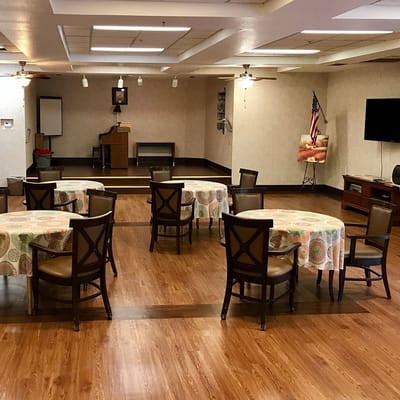 Interior view of a community event space with tables.