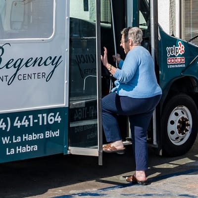 A resident entering a transport vehicle at the facility