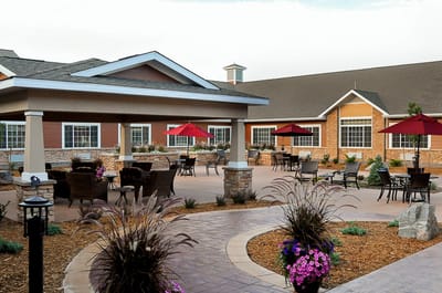 Outdoor seating area with umbrellas and landscaped pathways
