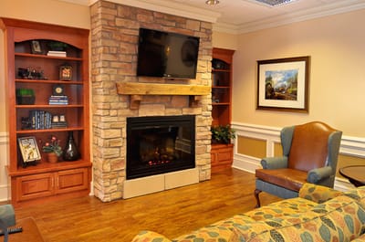 Cozy common area with stone fireplace and seating