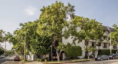 Exterior view of a senior living facility with trees