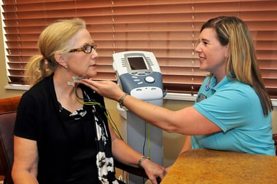 Healthcare professional attending to a resident's health check