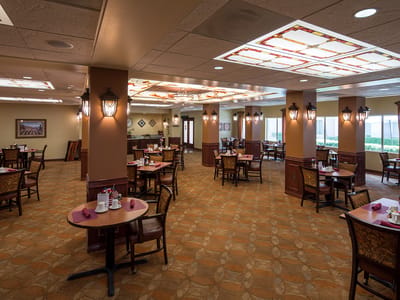 Dining area with tables and chairs set for meals