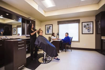 Residents enjoying hair services in the salon