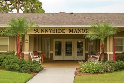 Front entrance of Sunnyside Manor with palm trees