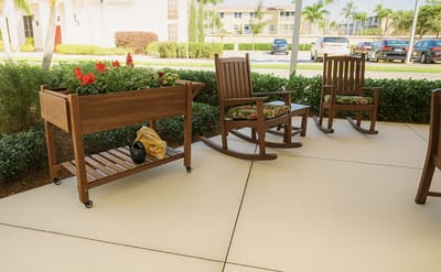 Outdoor seating area with rocking chairs and flowers