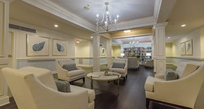 Bright common area with comfortable seating and bookshelves