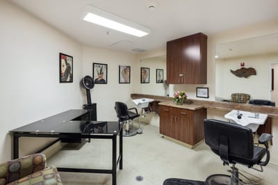 Interior view of a salon area with chairs and mirrors